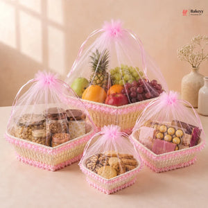 Three woven baskets filled with snacks, fruits, and cookies on a light surface.
