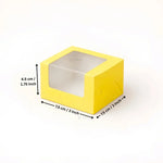Yellow square box with a clear plastic window on top, shown with dimension arrows and text indicating measurements of 7.5 cm by 7.