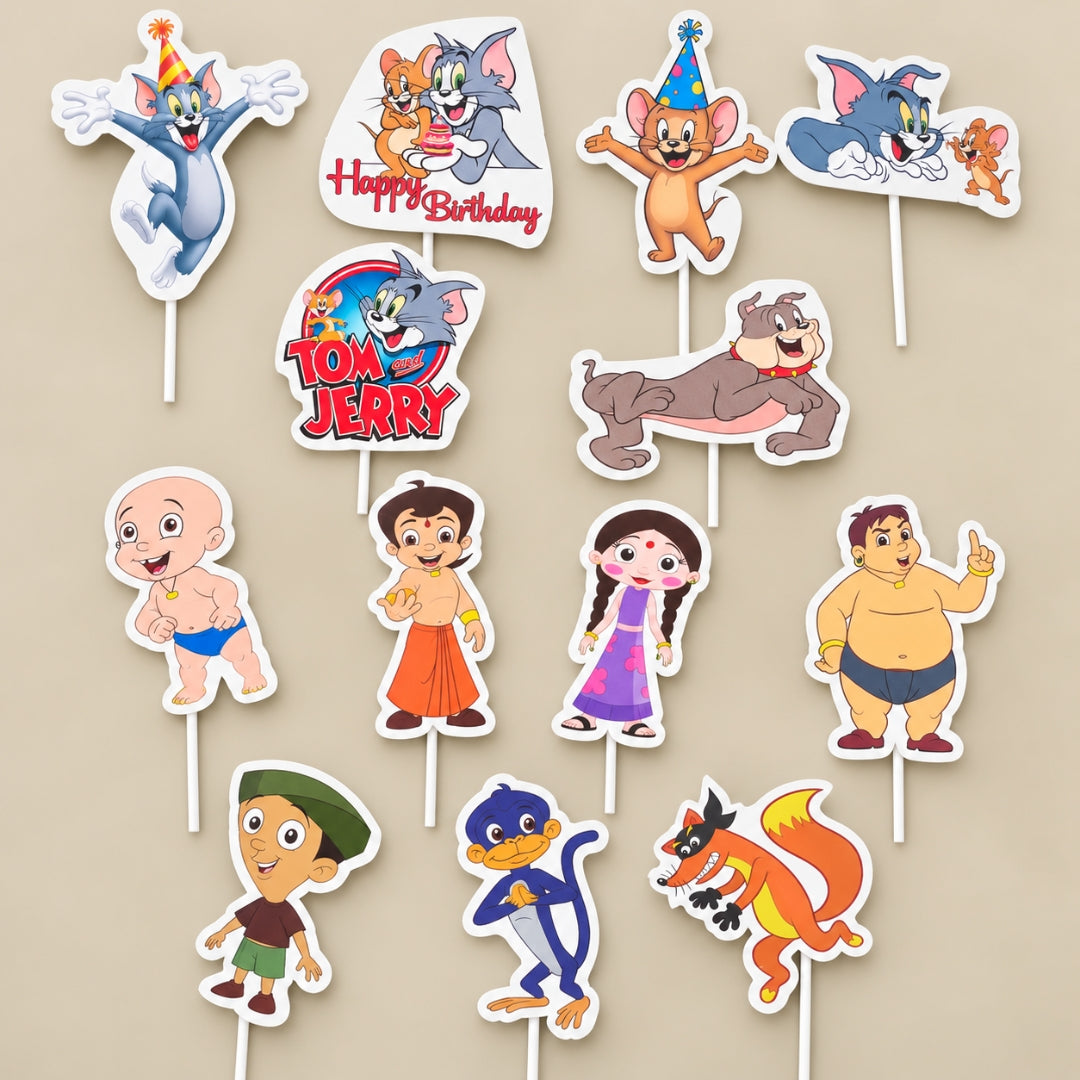 A set of cartoon character cake toppers on white sticks, featuring Tom and Jerry characters, a baby, a boy in an orange dhoti, a girl in a purple dress, a monkey, a fox, and other playful figures on a beige background.