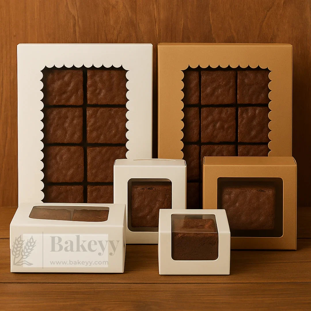 Assorted brown bakery boxes with clear windows displaying brownies, from Bakeyy.com wholesale baking supplies.