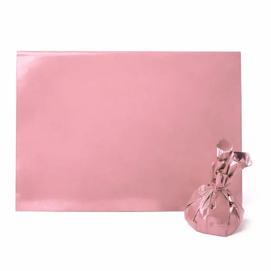 Pink metallic gift wrap sheet and wrapped package, baking supplies from Bakeyy India