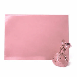 Pink metallic gift wrap sheet and wrapped package, baking supplies from Bakeyy India
