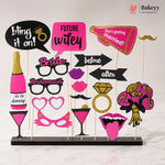 Collection of photo booth props with text and graphics on a stand, featuring the brand 'Bakeyy'.