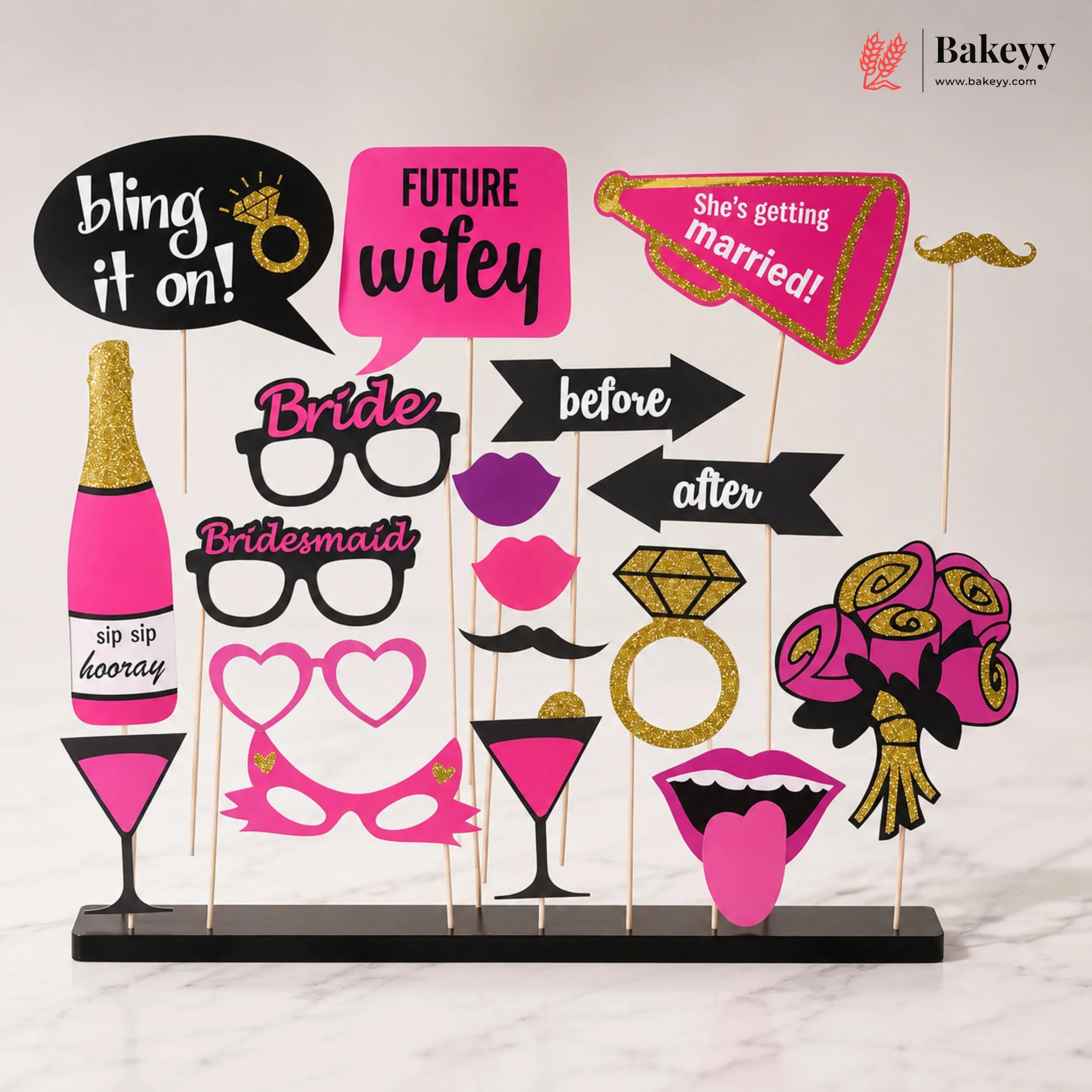 Collection of photo booth props with text and graphics on a stand, featuring the brand 'Bakeyy'.