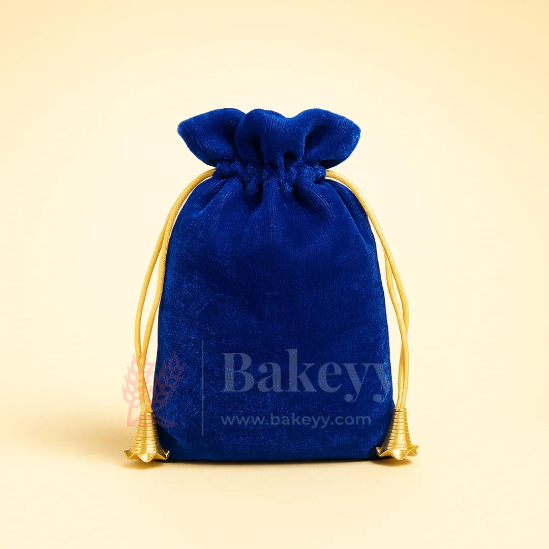 Royal blue velvet potli gift bag with gold drawstring from Bakeyy, ideal for hamper packaging.