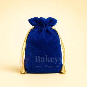 Royal blue velvet potli gift bag with gold drawstring from Bakeyy, ideal for hamper packaging.