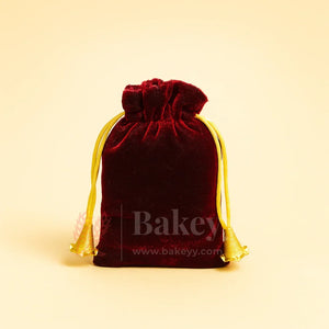 Red velvet potli bag with yellow drawstring, gift packaging from Bakeyy.com