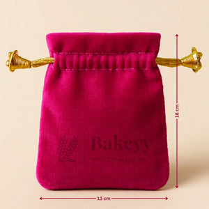 Bakeyy.com velvet potli gift bag in pink with gold drawstring, 18x13 cm, bakery packaging.