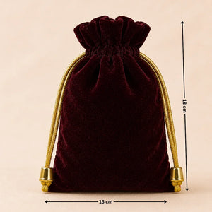 Velvet drawstring pouch with gold accents and measurements on a beige background