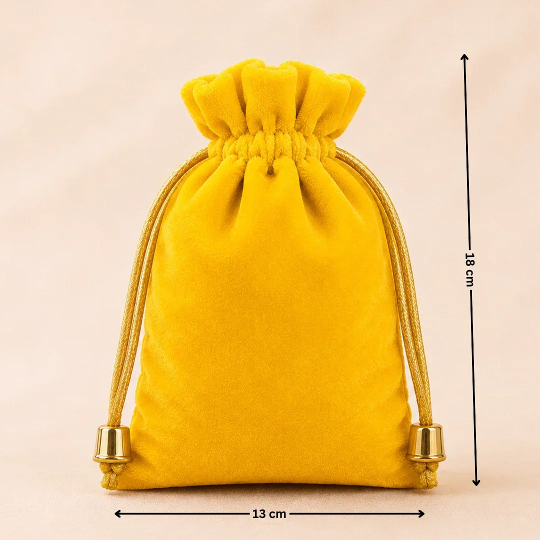 Yellow velvet drawstring pouch with measurements on a beige background