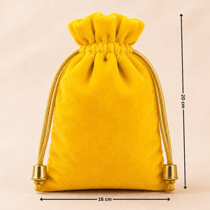Yellow velvet drawstring pouch with gold accents and measurements on a beige background