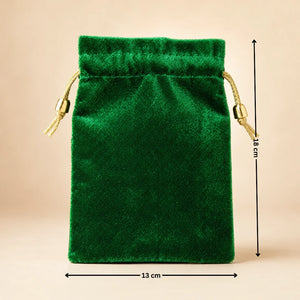 Green velvet drawstring pouch with measurements on a beige background