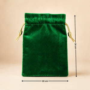 Green velvet drawstring pouch with measurements on a beige background