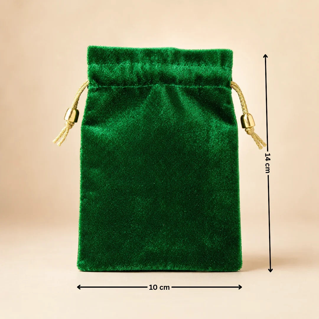 Green velvet drawstring pouch with measurements on a beige background