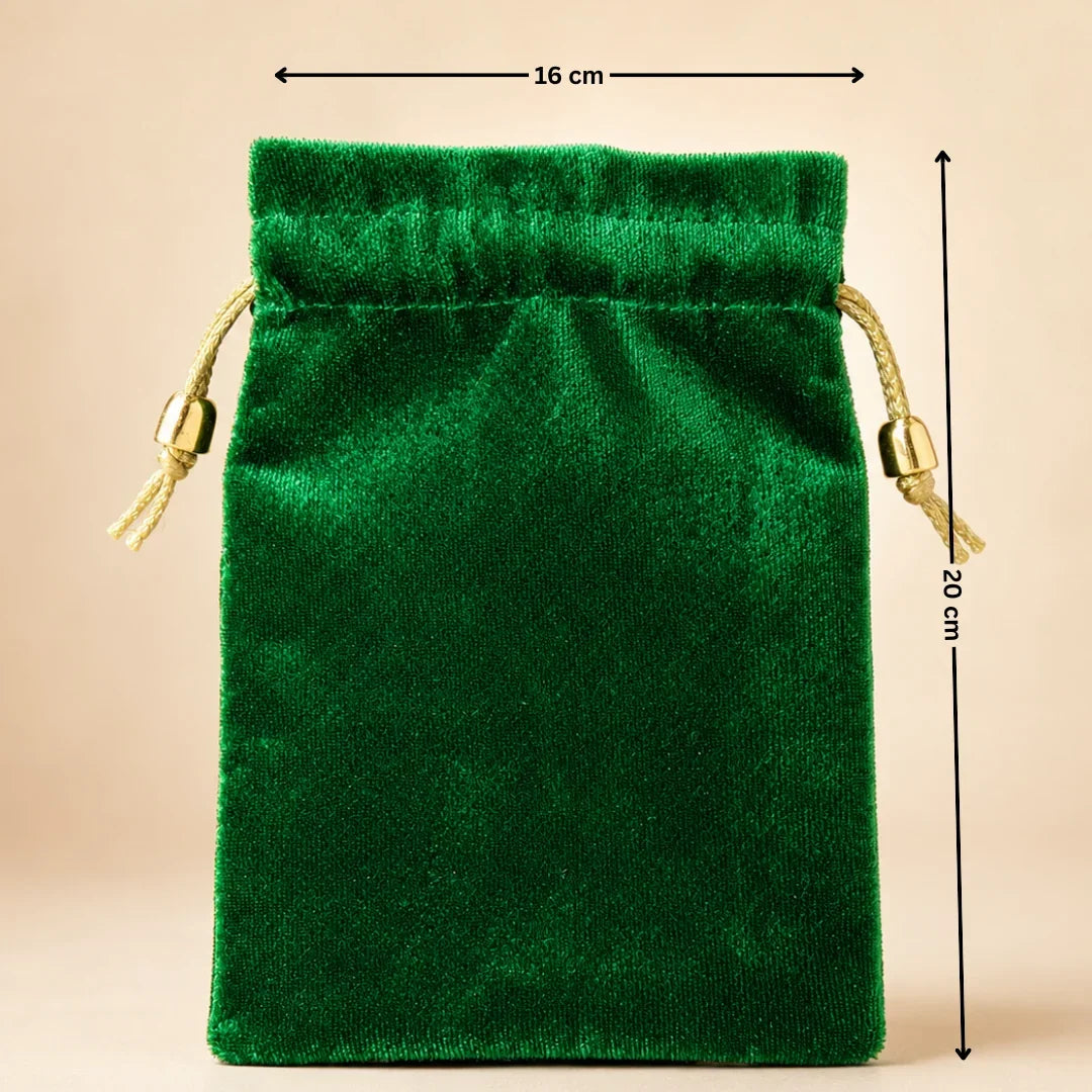 Green velvet drawstring pouch with measurements on a beige background