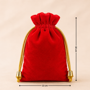 Red velvet drawstring pouch with gold accents and measurements on a beige background