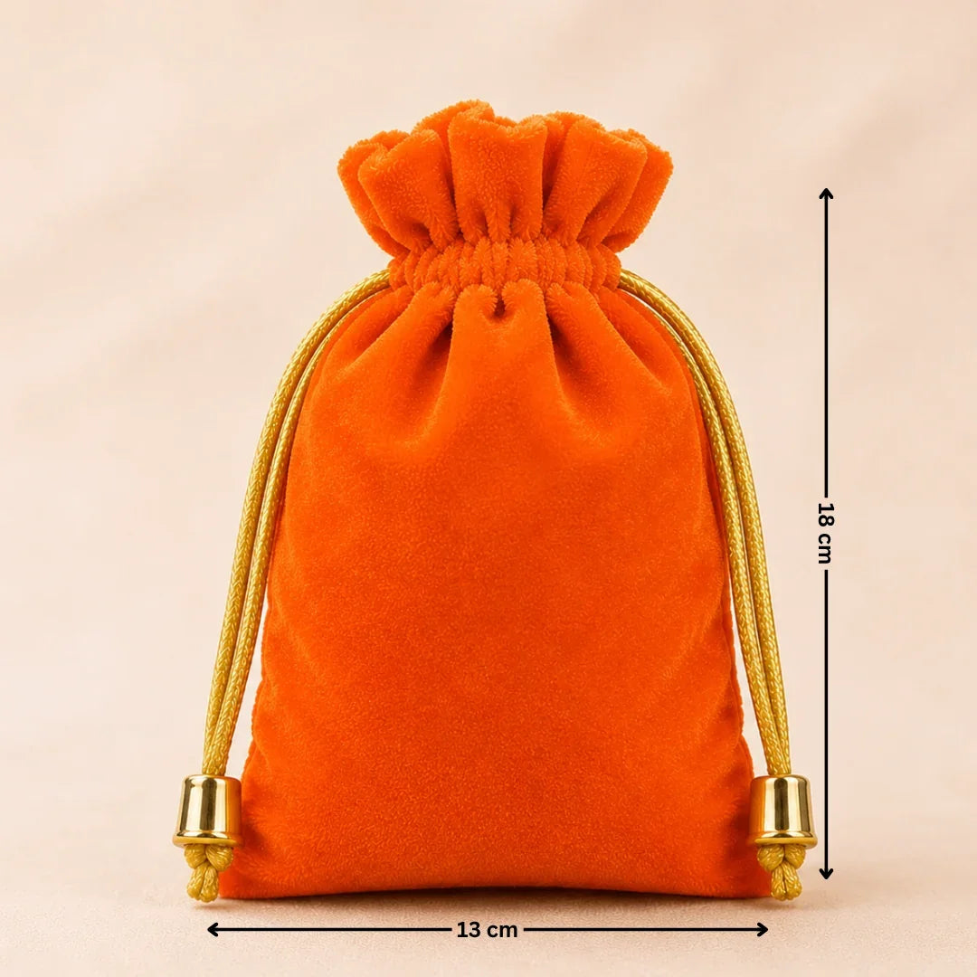 Orange velvet drawstring pouch with gold drawstrings and measurements on a beige background