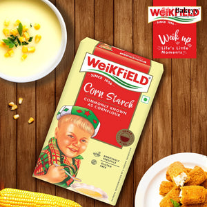 Weikfield corn starch package on a wooden table with food items and brand logo.