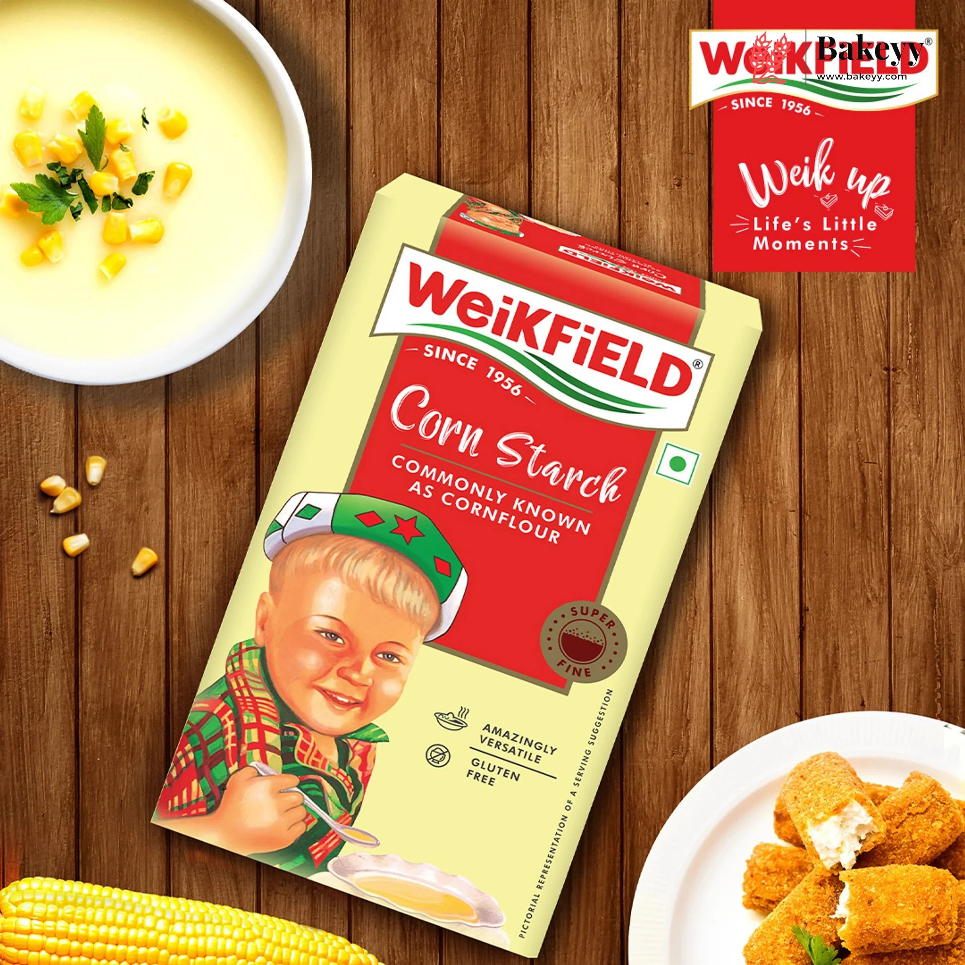 Weikfield corn starch package on a wooden table with food items and brand logo.