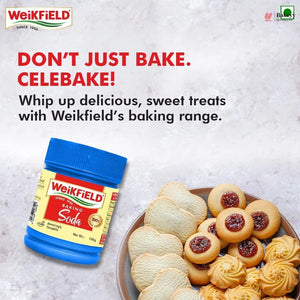 Weikfield baking soda container with cookies on a plate against a light gray background