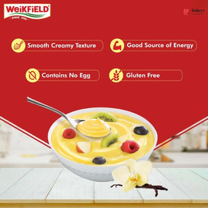 Fruit bowl with vanilla pudding on a white surface, featuring Weikfield logo and product features.