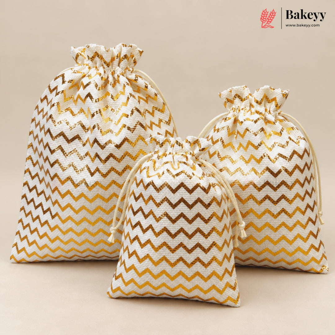 Three drawstring gift bags with a gold and white chevron pattern, arranged on a beige background. A Bakeyy logo is visible in the top right corner.