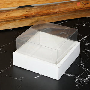 White jewelry box with clear lid on a black marble surface, with 'Bakeey' brand visible.