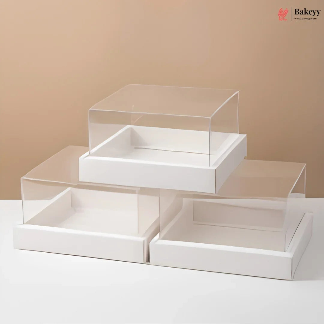 White display box with clear acrylic lid on a beige background