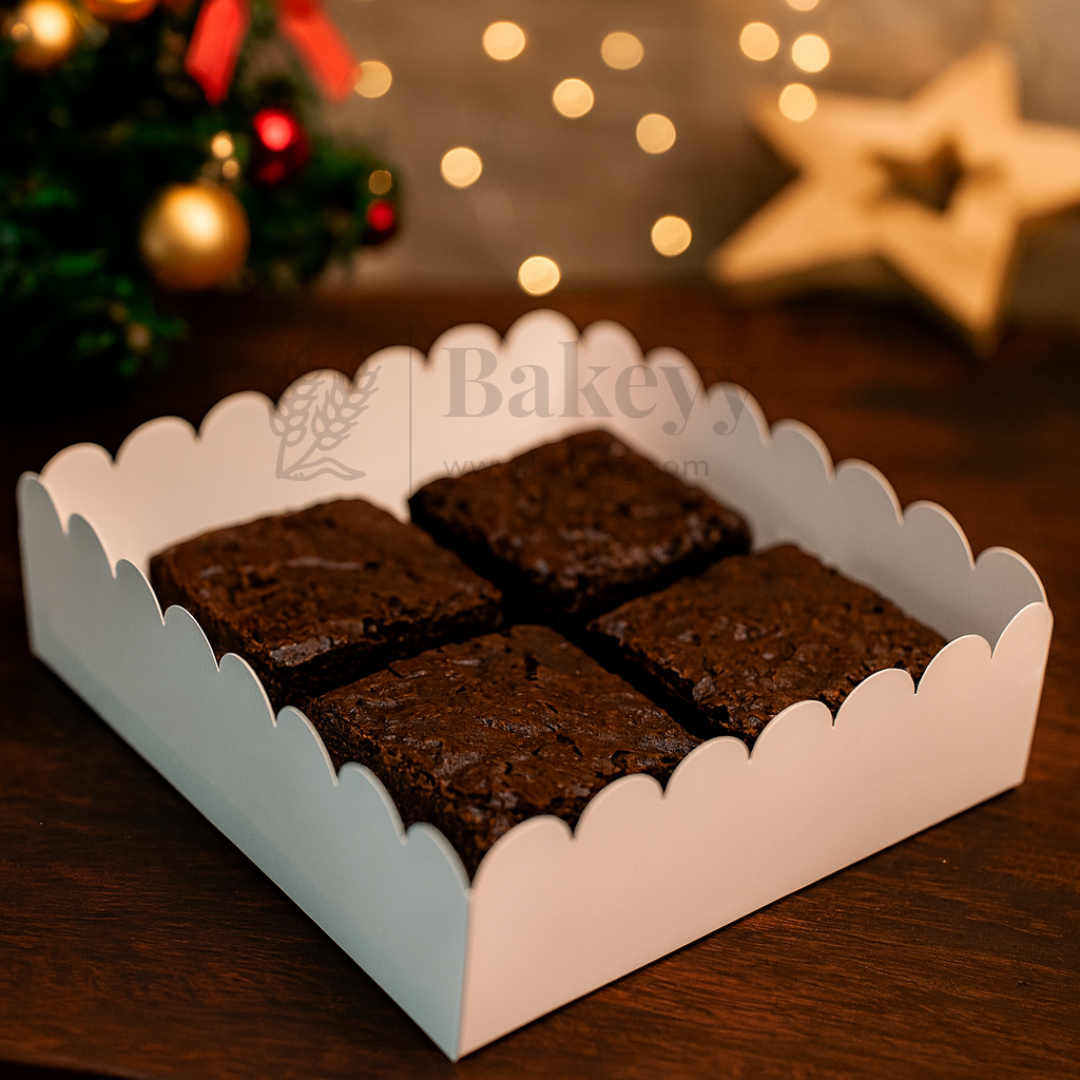 Box of brownies with a festive background featuring lights and a star.