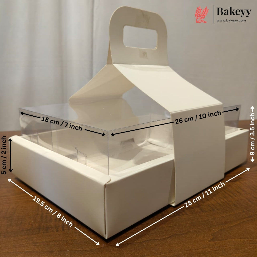 White cardboard bakery box with a clear plastic window and handle, shown on a wooden surface with overlaid dimension arrows and labels.