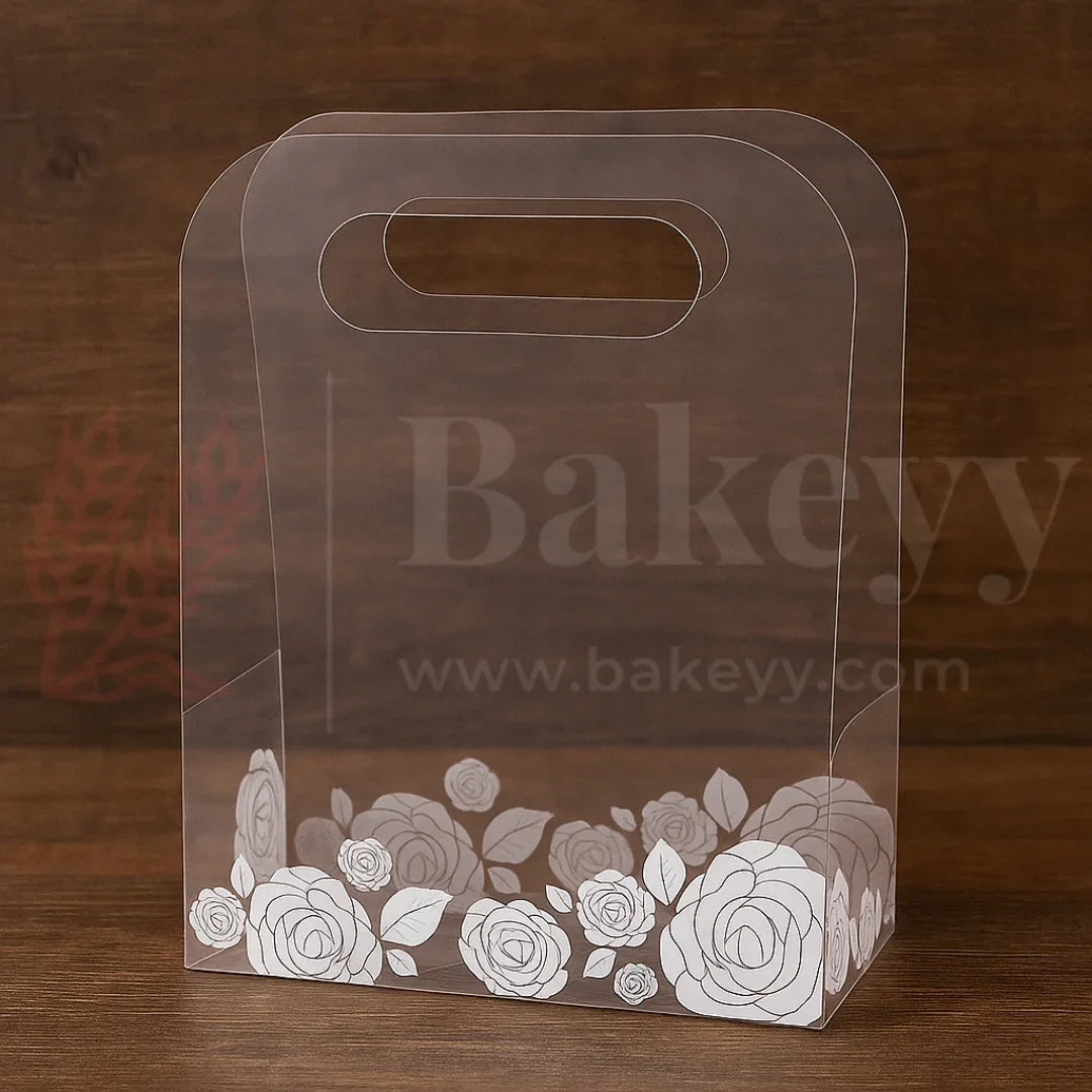 Clear cake box with floral design on a wooden background, featuring the brand 'Bakeyy'.