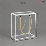 Small clear cube with yellow rope inside, dimensions labeled, on a gray background