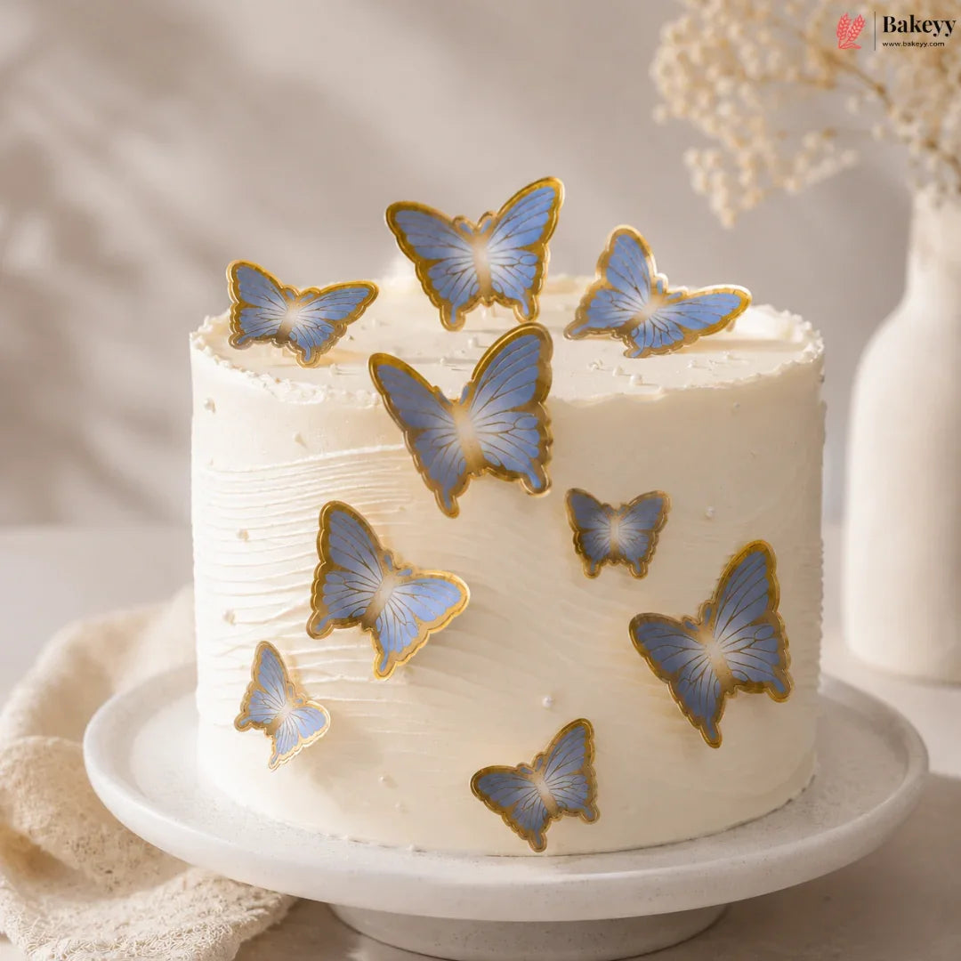 White cake with blue butterfly decorations on a neutral background