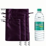 Three dark purple satin drawstring pouches of different sizes shown next to a 0.5 L Bisleri mineral water bottle for scale, with printed size measurements in centimeters.