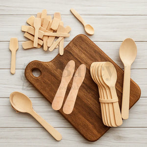 Assorted biodegradable wooden cutlery on a wooden board, ideal for bakery supplies from Bakeyy.com