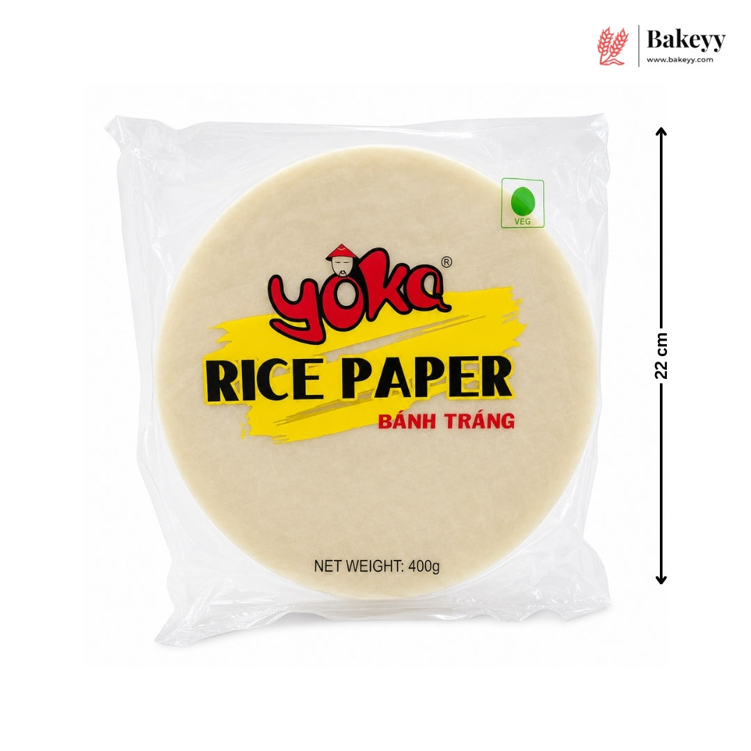 A package of Yoka Rice Paper (Bânh Trâng) on a white background, featuring a black dimension arrow indicating a height of 22 cm. The package contains a round beige rice paper sheet with a yellow and red label.