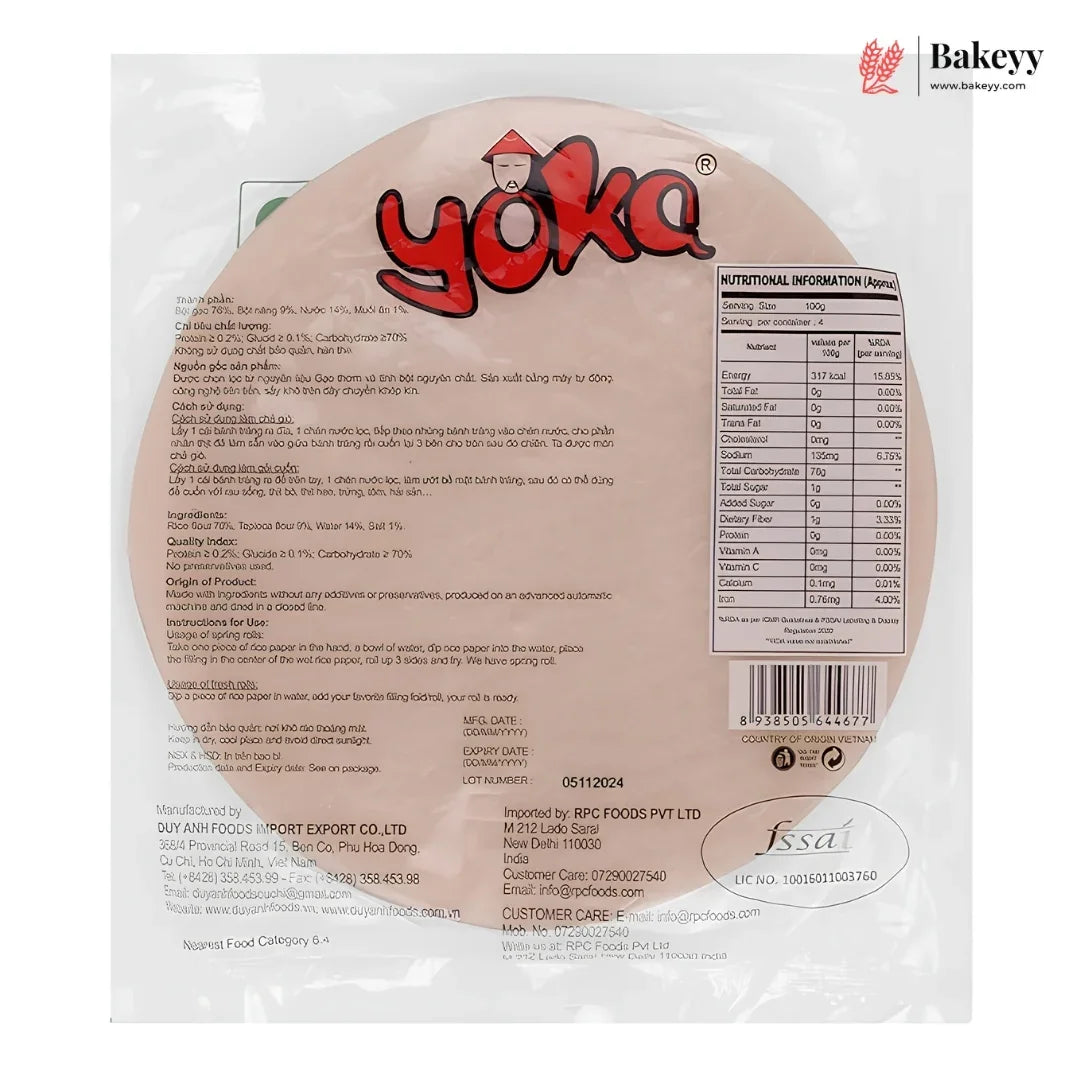 Back view of a packaged round rice cake on a white background, showing the Bakeyy logo, product details, nutrition facts, and a barcode. The package is clear plastic with printed text and branding.