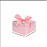 Pink gift box with white polka dots and a pink ribbon, featuring dimensions on a white background.