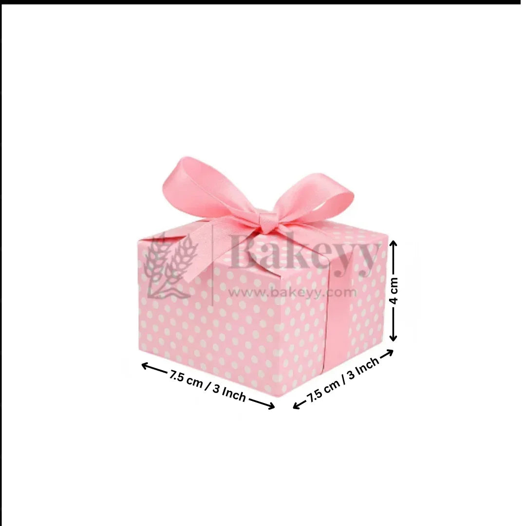 Pink gift box with white polka dots and a pink ribbon, featuring dimensions on a white background.