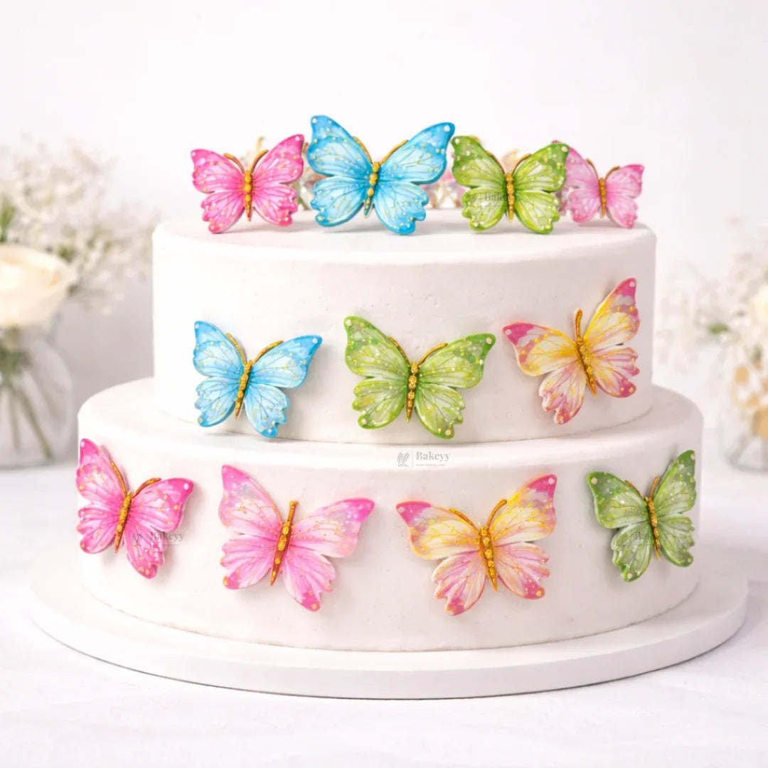 Two-tier cake decorated with colorful butterfly toppers from Bakeyy, ideal for baking supplies