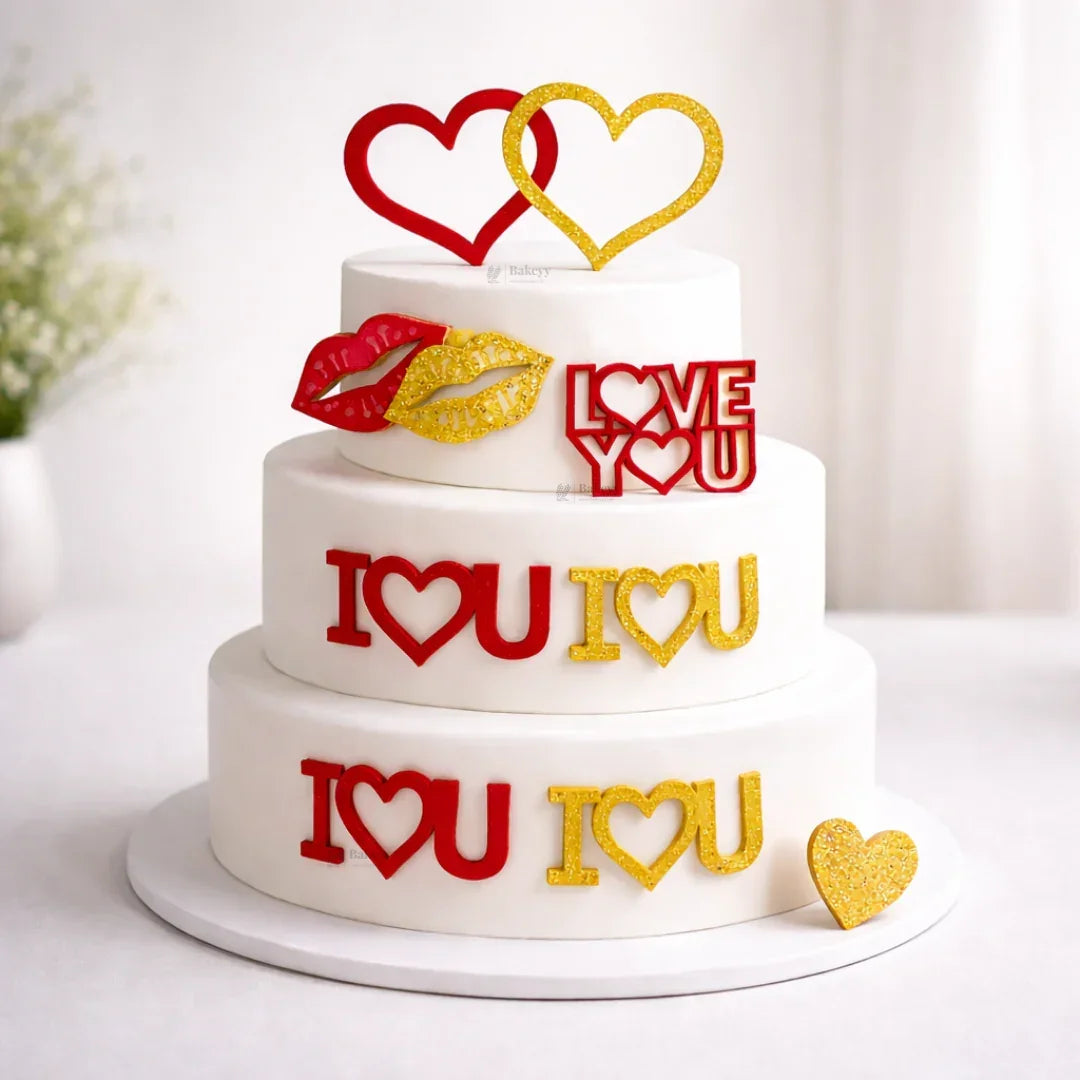 Three-tiered cake with 'I LOVE YOU' text in red and gold on a white background