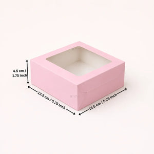 A pink square gift box with a clear window top, shown with dimension arrows and labels indicating 13.5 cm by 13.