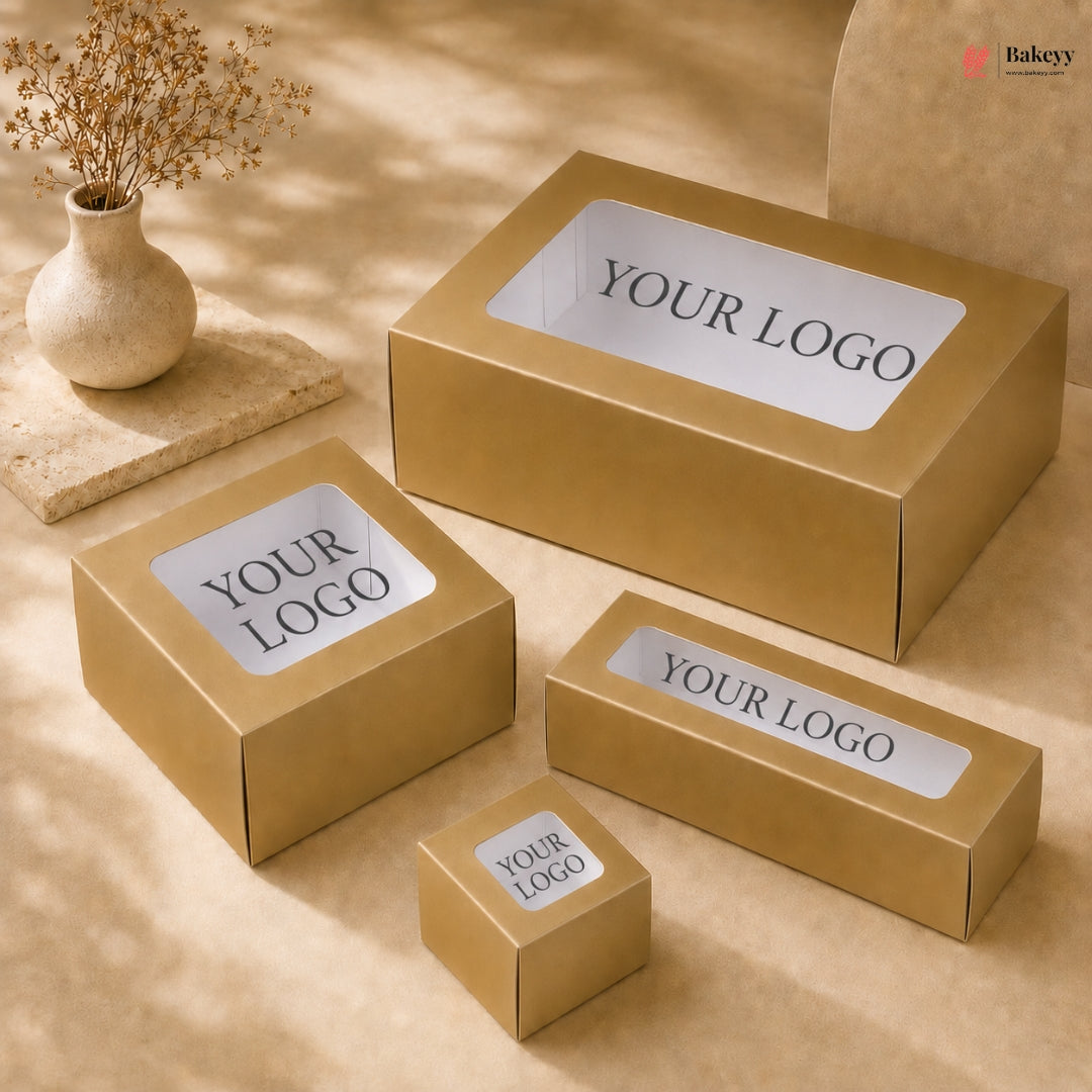 Gold boxes with 'YOUR LOGO' labels on a beige surface with a vase of dried flowers.