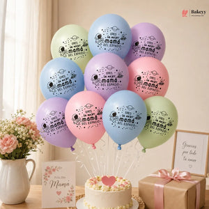 Decorative balloons with messages, a cake, and gift box on a table with a light background.