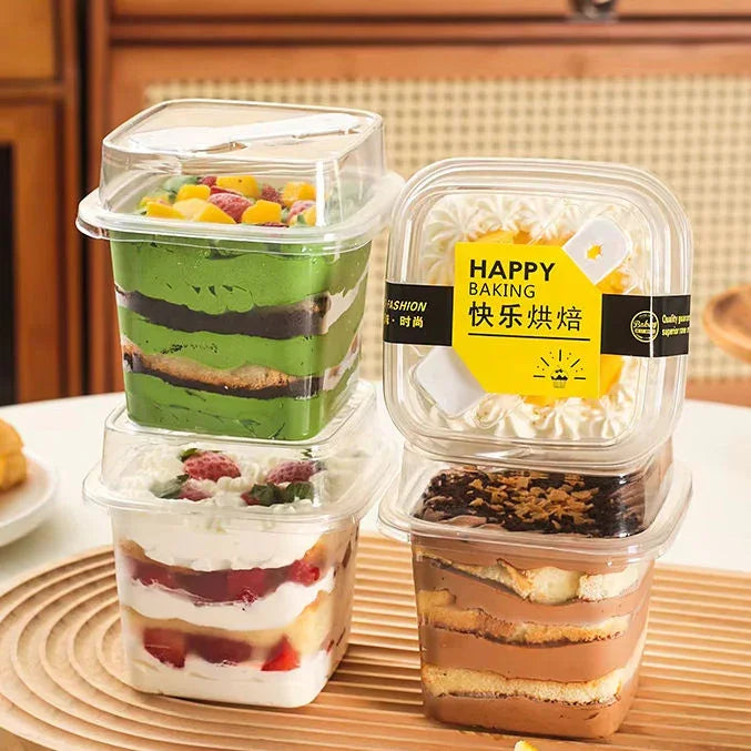 Assorted layered desserts in clear plastic takeaway boxes, perfect for bakery packaging from Bakeyy.com