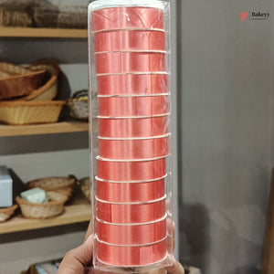 Pack of red baking cups held in front of a neutral background