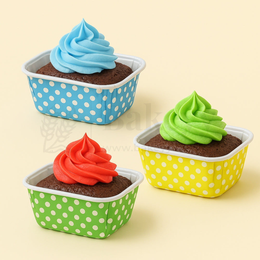 Three cupcakes with colorful frosting in polka dot containers on a beige background
