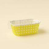 Yellow polka dot container on a beige background