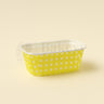 Yellow polka dot container on a beige background