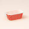 Rectangular paper basket with red and white polka dot pattern on a beige background